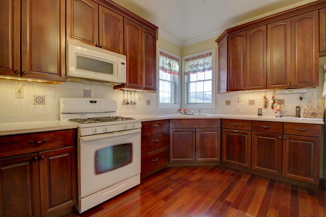 kitchen featuring backsplash, ornamental molding, white appliances, sink, and dark hardwood / wood-style floors