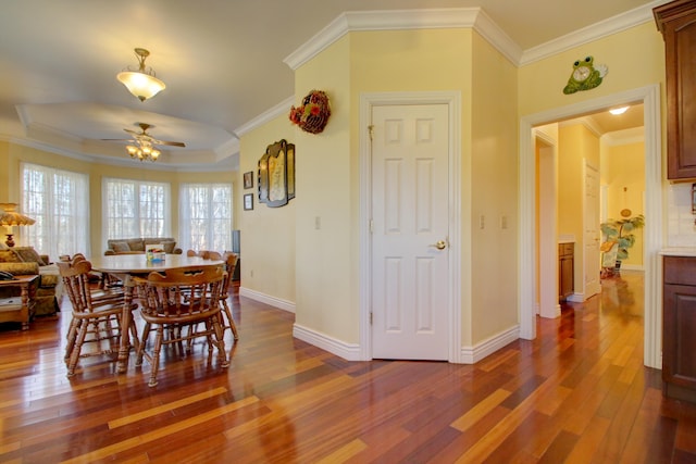 dining area with ceiling fan, crown molding, and wood-type flooring