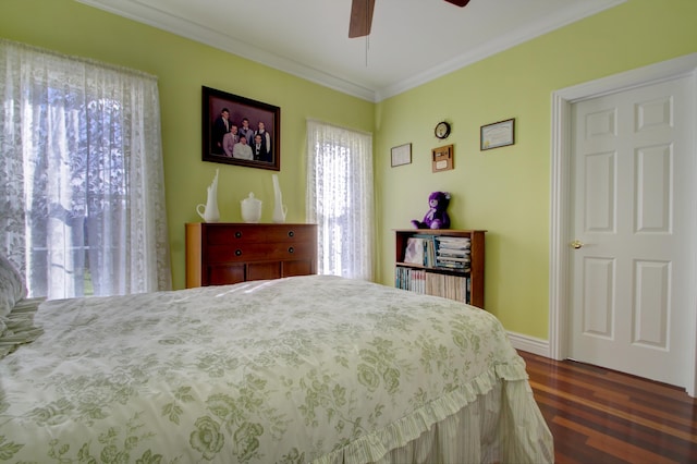 bedroom featuring ceiling fan, dark hardwood / wood-style floors, and ornamental molding