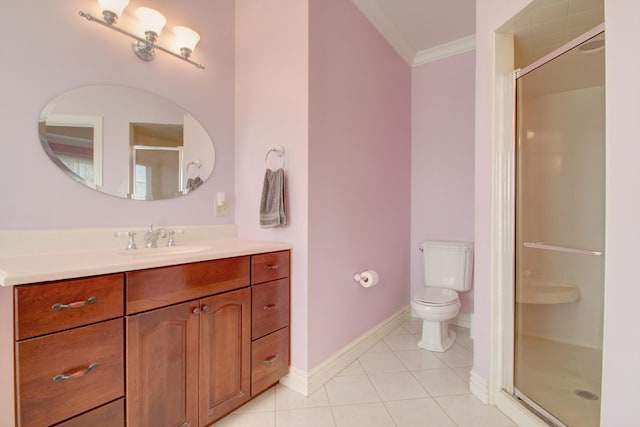 bathroom with tile patterned floors, toilet, vanity, a shower with shower door, and ornamental molding