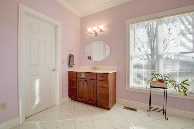 bathroom featuring tile patterned flooring, vanity, and crown molding