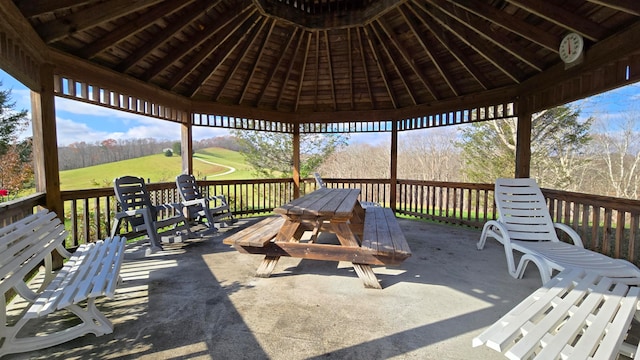 deck featuring a gazebo, a patio, and a yard