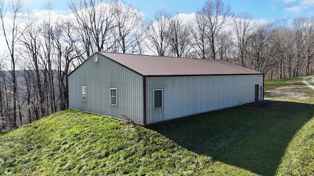 view of outbuilding featuring a lawn