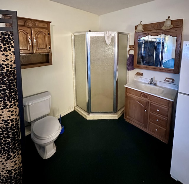 bathroom featuring vanity, toilet, and a shower with shower door