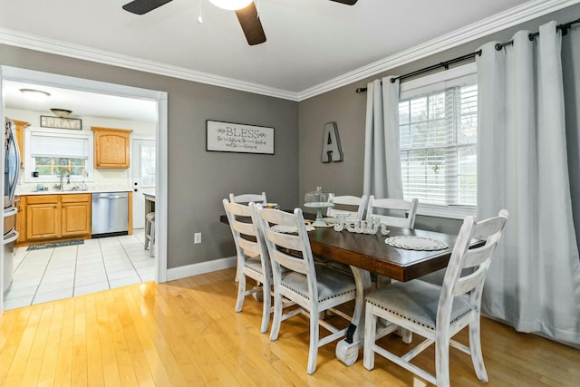 dining space featuring light hardwood / wood-style flooring, ceiling fan, ornamental molding, and sink