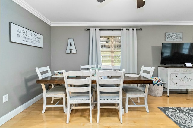 dining space with ceiling fan, ornamental molding, and hardwood / wood-style flooring