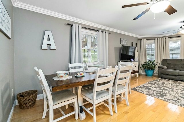 dining area with light hardwood / wood-style floors, ceiling fan, and crown molding