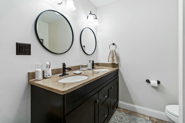 bathroom with tile patterned floors, vanity, and toilet