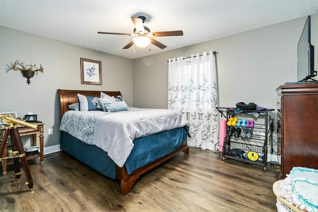 bedroom with ceiling fan and dark wood-type flooring