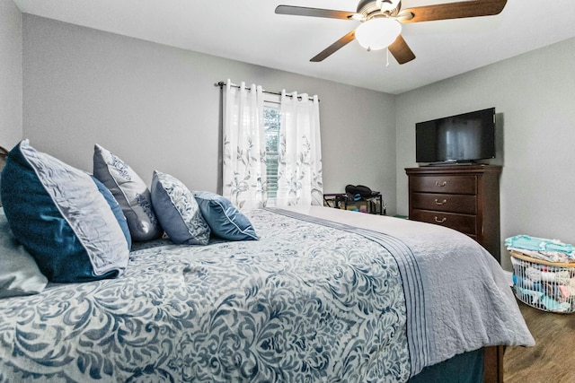 bedroom with ceiling fan and wood-type flooring