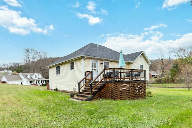 rear view of house featuring a yard and a wooden deck