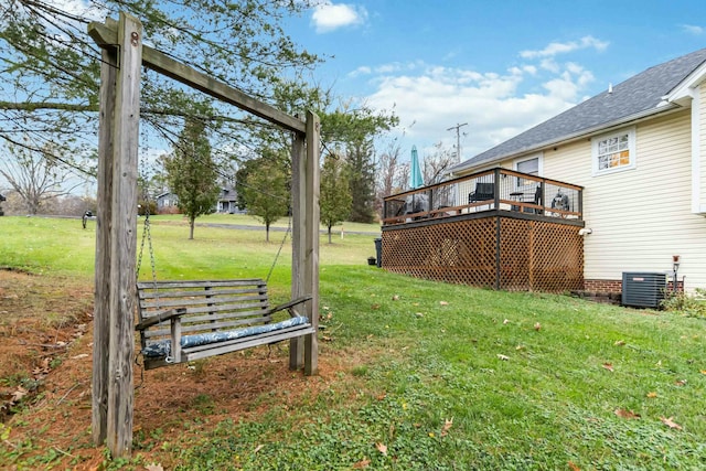 view of yard featuring central AC and a deck