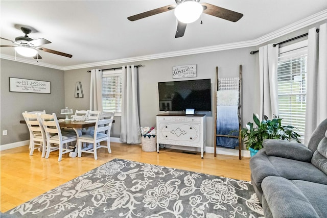 living room with wood-type flooring and ornamental molding