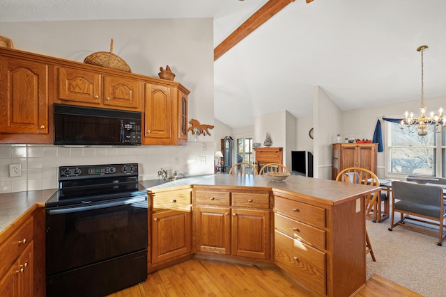 kitchen featuring black appliances, a notable chandelier, light hardwood / wood-style floors, and tasteful backsplash