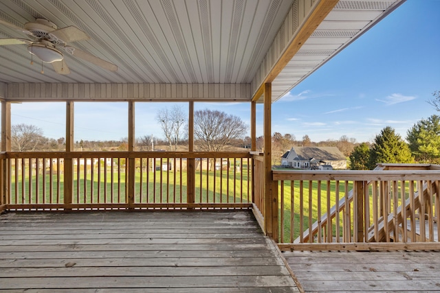 wooden deck with ceiling fan and a yard