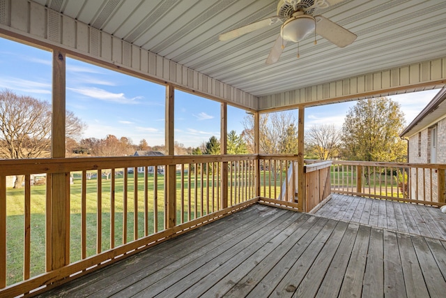 unfurnished sunroom with ceiling fan