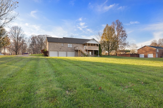 view of yard featuring a wooden deck and a garage