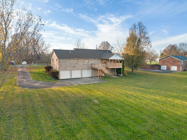 exterior space with a lawn, a garage, and a wooden deck