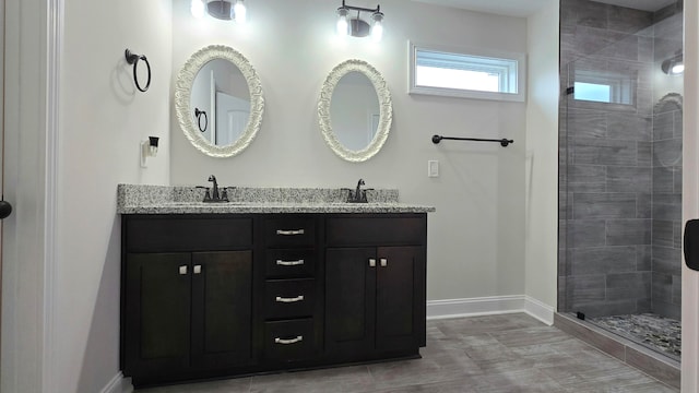 bathroom featuring vanity and tiled shower