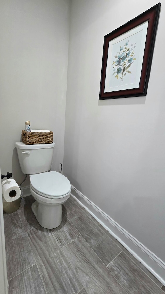 bathroom with toilet and wood-type flooring