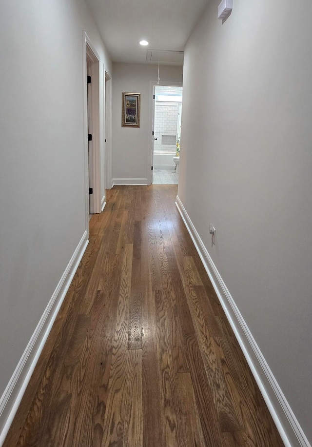 hallway with dark hardwood / wood-style flooring