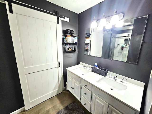 bathroom featuring hardwood / wood-style flooring, vanity, and a textured ceiling