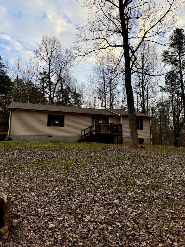 back of house with a wooden deck