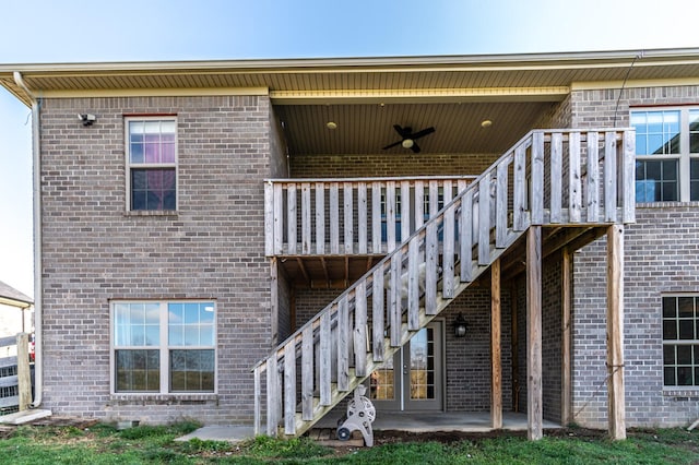 back of property with ceiling fan and a patio