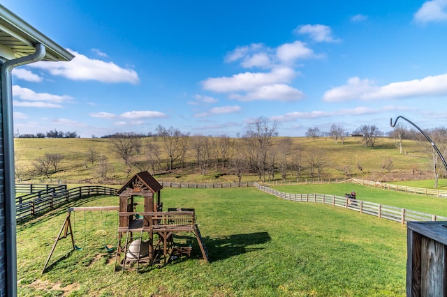 view of yard with a playground and a rural view