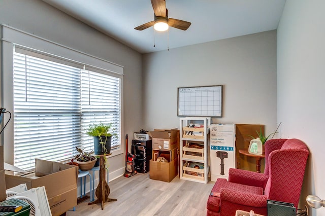 sitting room featuring ceiling fan and light wood-type flooring