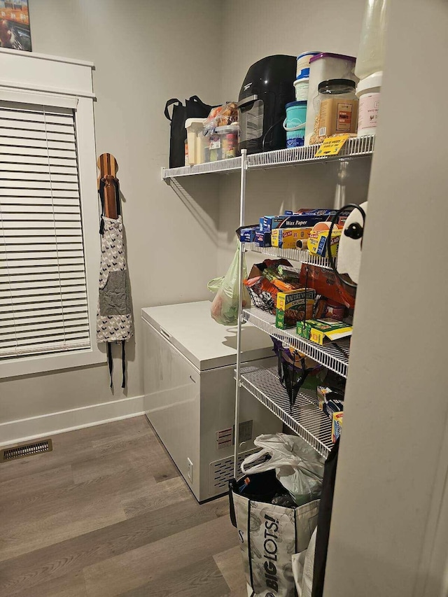 clothes washing area with hardwood / wood-style floors