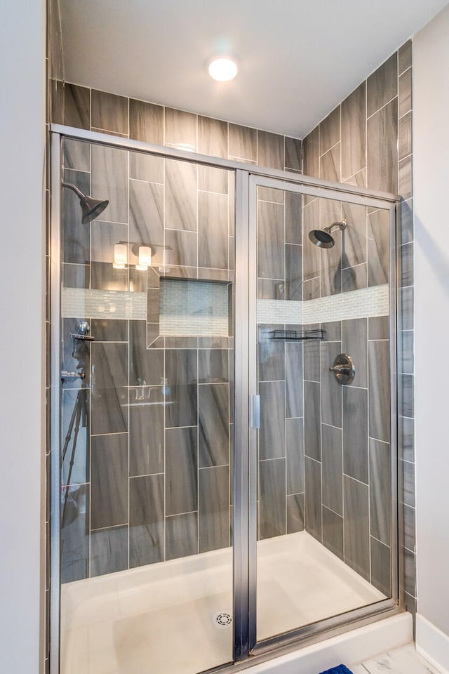 bathroom featuring a shower with shower door