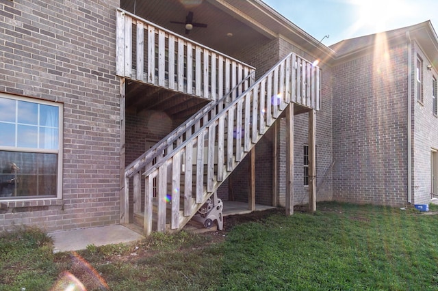 exterior space featuring a lawn and ceiling fan