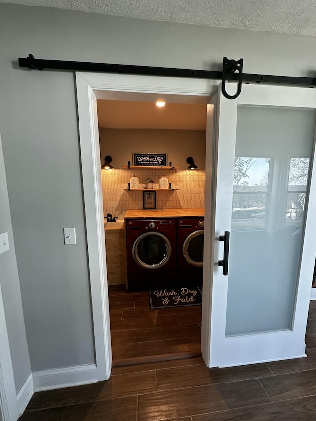2458 High Bridge Rd, Lancaster, KY 40444 - laundry area featuring washer and dryer, wood finish floors, and a barn door