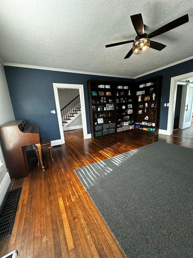 interior space with crown molding, dark wood-type flooring, and a textured ceiling