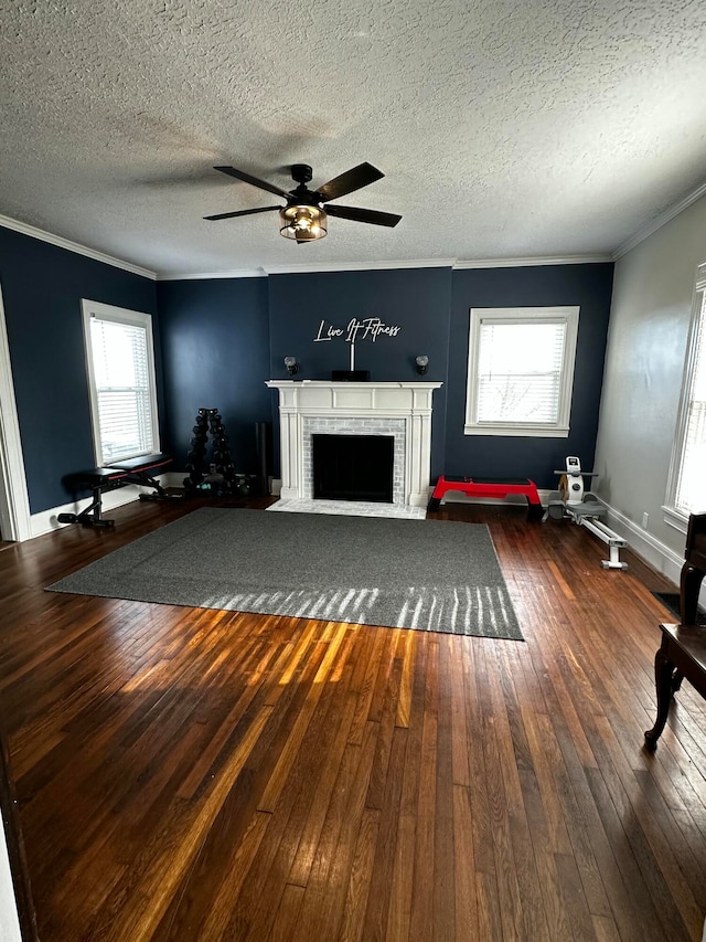 unfurnished living room with plenty of natural light, a textured ceiling, and dark wood-type flooring