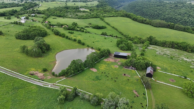 birds eye view of property with a rural view and a water view