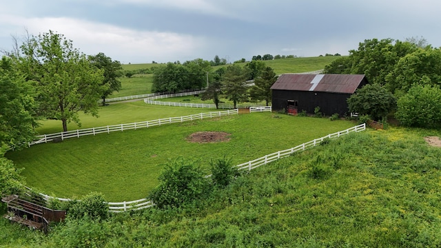 view of yard featuring an outbuilding and a rural view