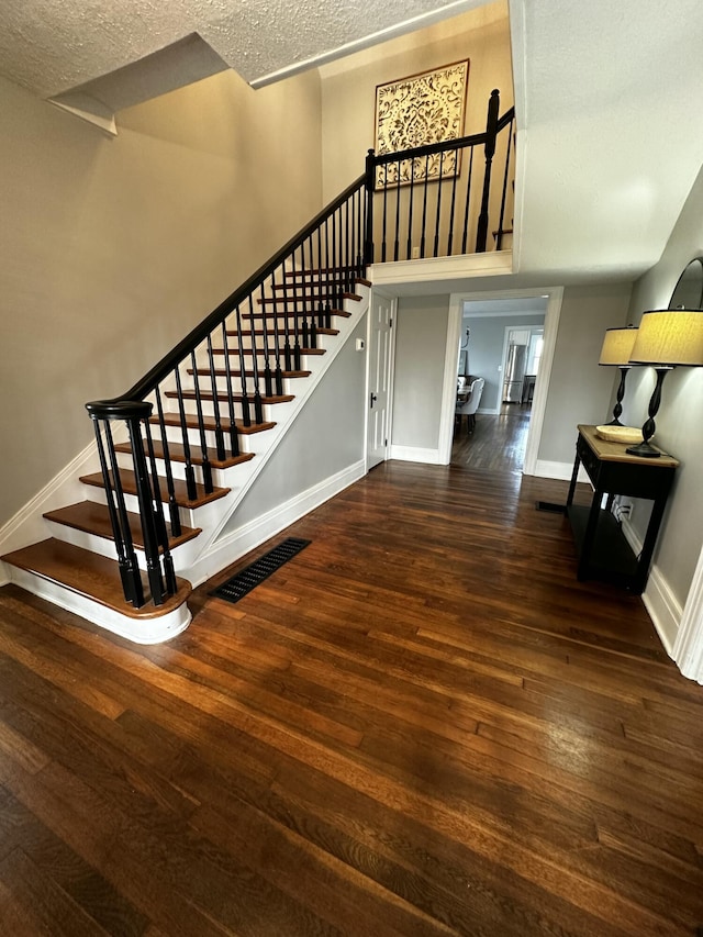 2458 High Bridge Rd, Lancaster, KY 40444 - staircase featuring wood-type flooring, baseboards, and a textured ceiling