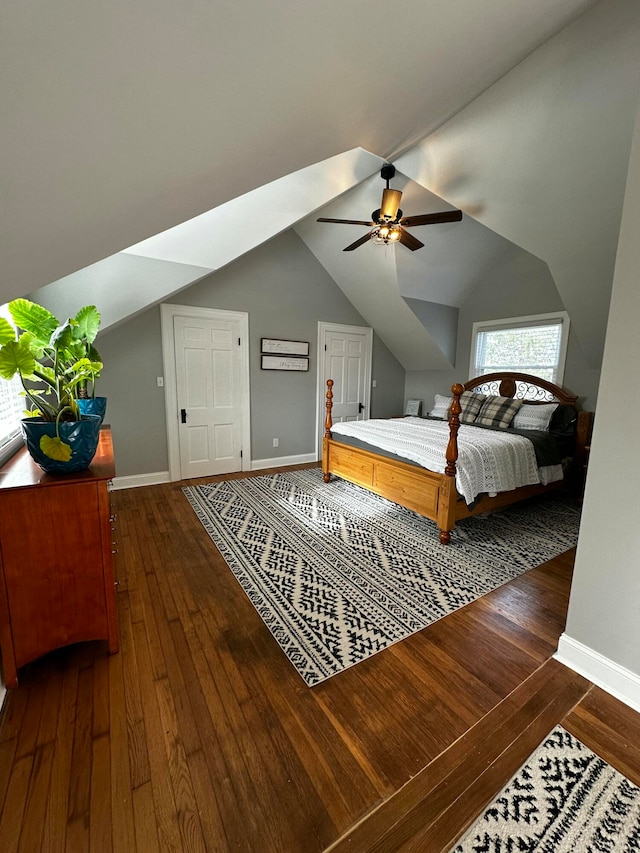 bedroom featuring dark hardwood / wood-style flooring, ceiling fan, and lofted ceiling