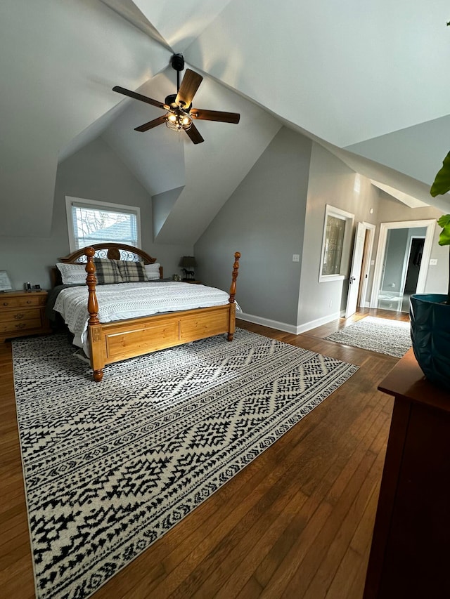 bedroom with dark hardwood / wood-style flooring, vaulted ceiling, and ceiling fan