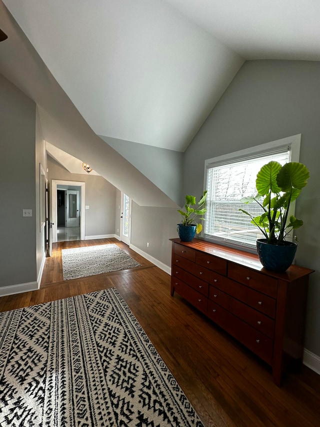 bonus room featuring dark wood-type flooring and lofted ceiling