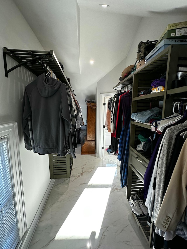 walk in closet with vaulted ceiling