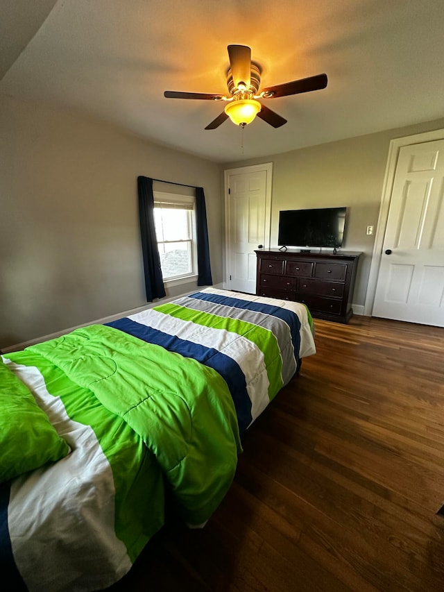 bedroom featuring ceiling fan and dark hardwood / wood-style flooring