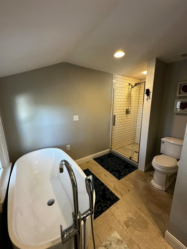 bathroom with lofted ceiling, toilet, and a shower with shower door