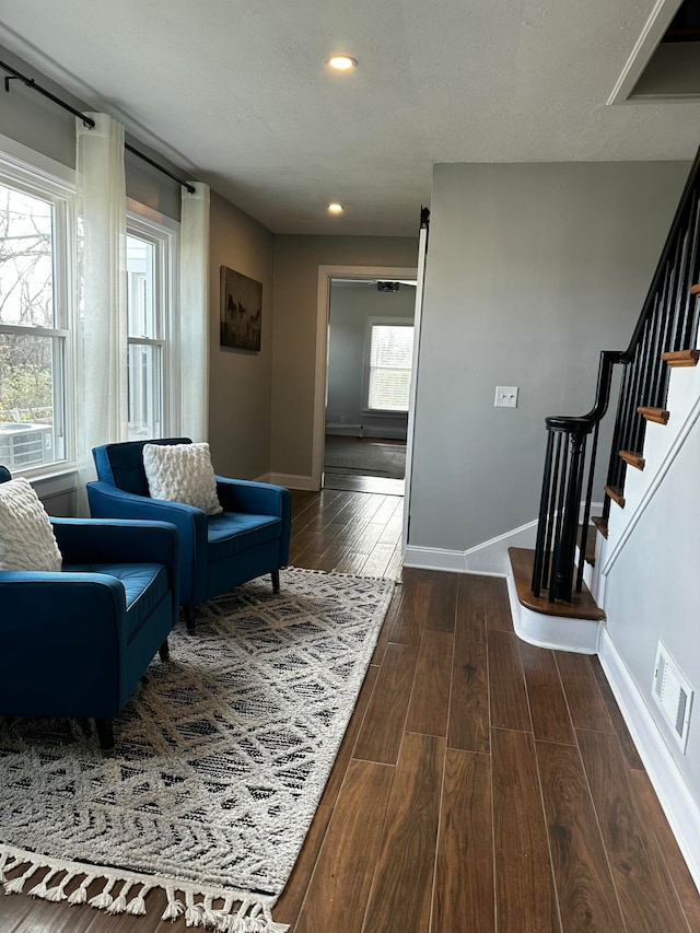 interior space featuring a textured ceiling and dark hardwood / wood-style floors