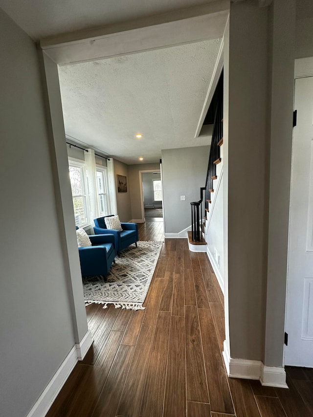 interior space with dark hardwood / wood-style flooring and a textured ceiling