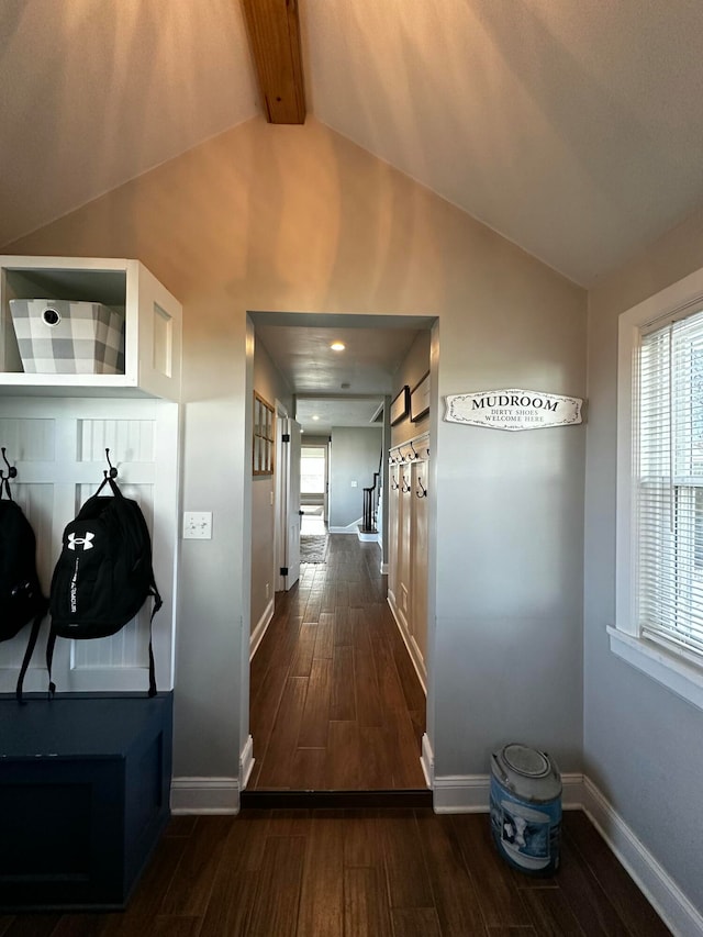 hall with vaulted ceiling with beams and dark hardwood / wood-style floors