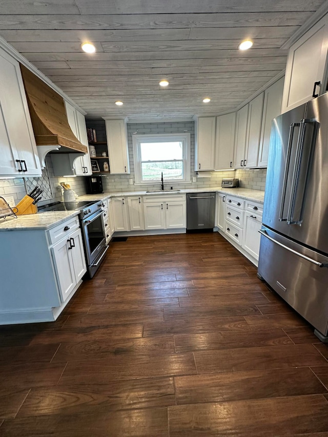 kitchen with light stone countertops, sink, stainless steel appliances, dark hardwood / wood-style flooring, and white cabinets