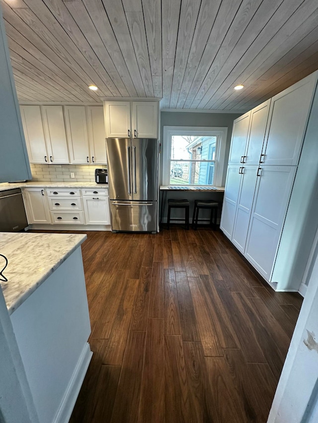 kitchen with white cabinets, appliances with stainless steel finishes, wooden ceiling, and dark wood-type flooring